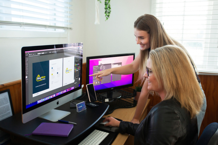 Image of Renee Orlop and designer Jess having a meeting in the Merge Media office