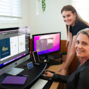 What its like to work with Merge Media Merge Media lenaing over computers smiling while working